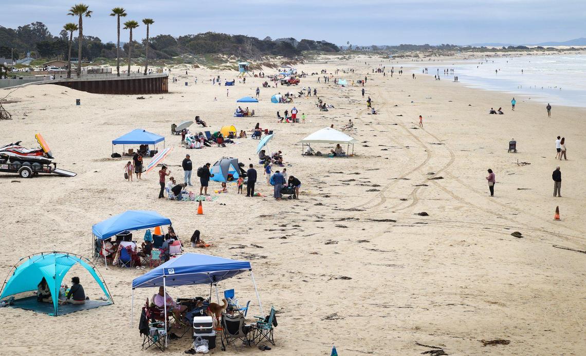 A Memorial Day crowd lines the sand in Pismo Beach with tents south of the pier on May 29, 2023.
