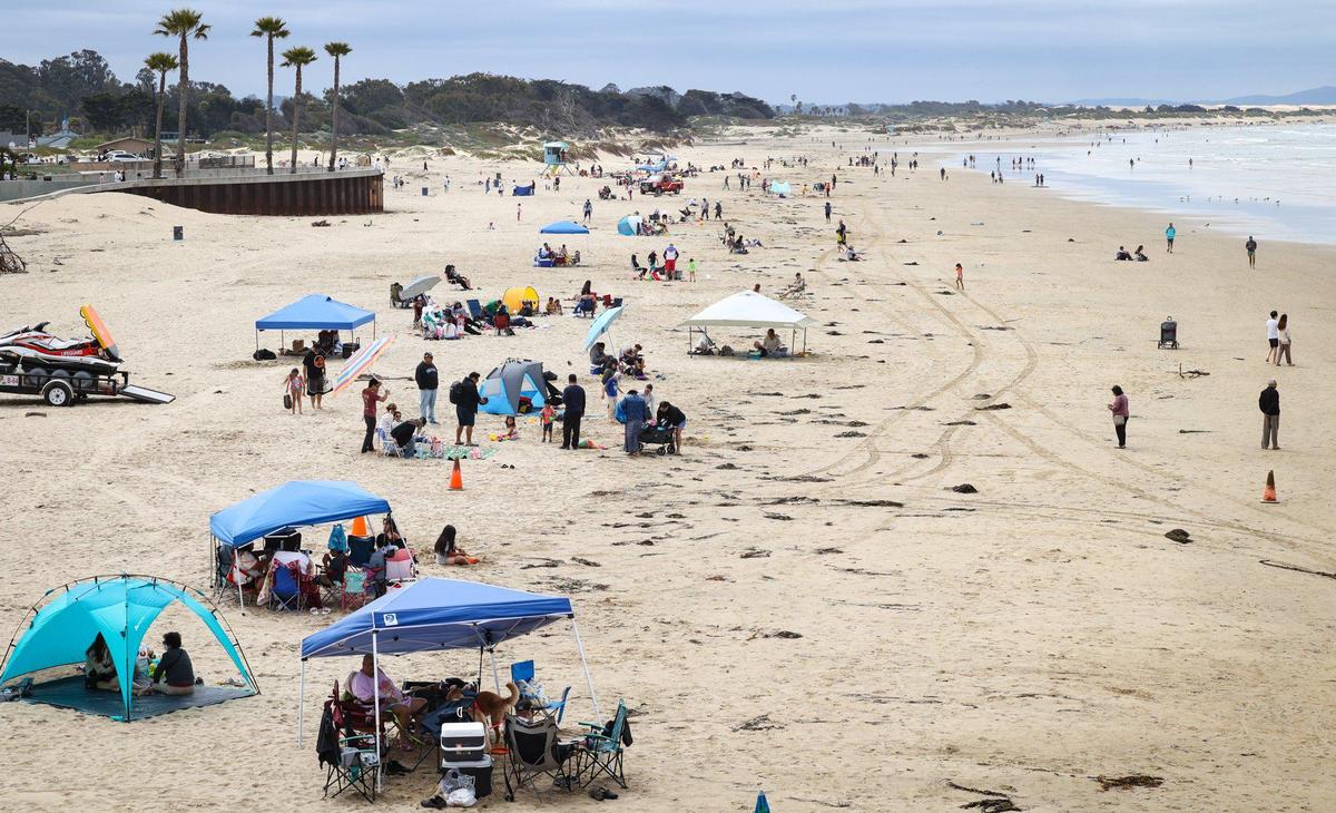 Memorial Day crowd at Pismo Beach lines the sand with tents south of the pier May 29, 2023.