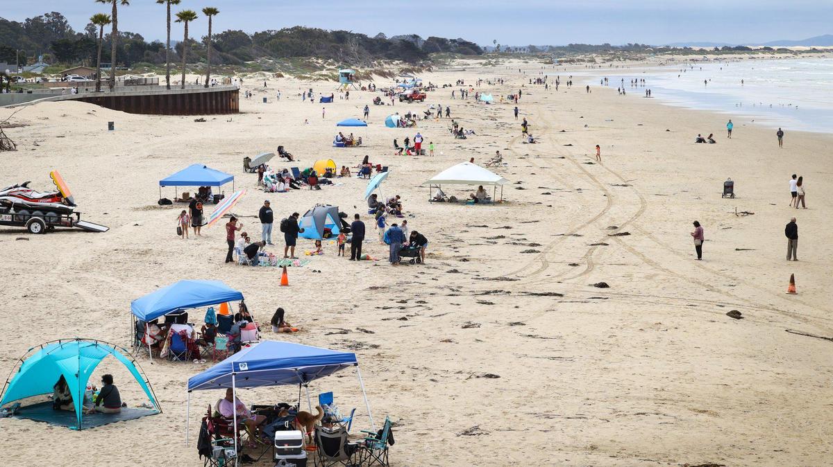 Memorial Day crowd at Pismo Beach lines the sand with tents south of the pier May 29, 2023.