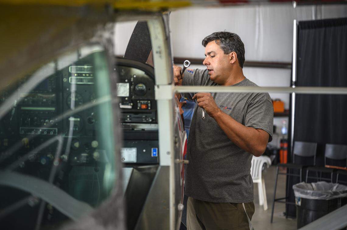 Cal Poly professor Paul Iscold works on one of the planes on April 22, 2022, at an undisclosed location in Arizona ahead of a daredevil mid-air plane swap on April 24. Two skydiving pilots Luke Aikins and Andy Farrington nearly pulled off the stunt with one of the two completing the swap and landing the plane safely.