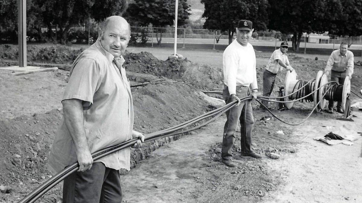 Roy Poletti, left, Frank Reed, Shugi Rodriguez and Will Hairgrove unroll a couple of spools in the work that will provide Frank Holt Field with lights. Published on Sept. 4, 1971.