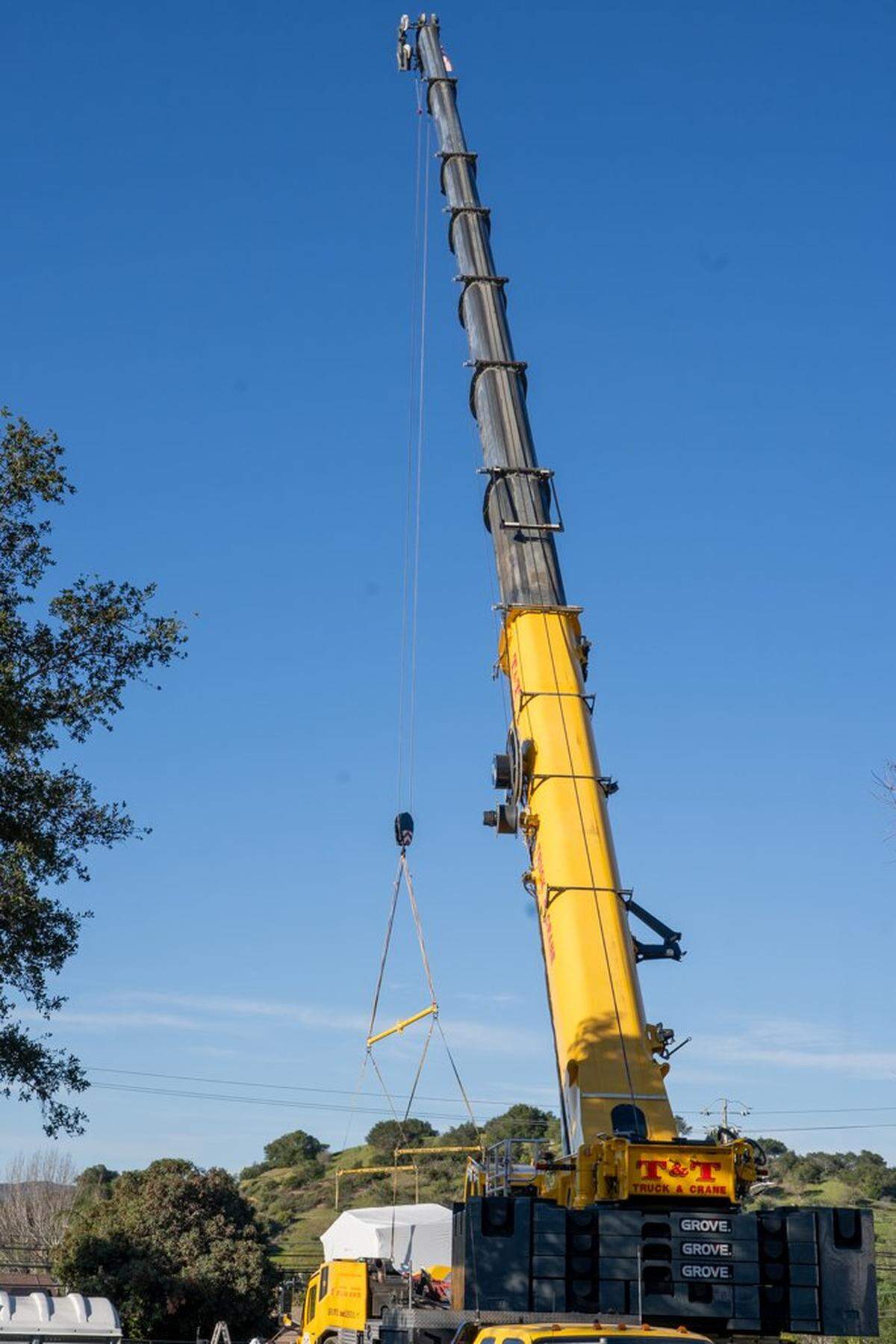 A crane lowers a home onto its permanent home in the Welcome Home Village project site on Thursday, Feb. 5, 2026. The Welcome Home Village will consist of 54 prefabricated, 3D-printed homes that will house homeless individuals.