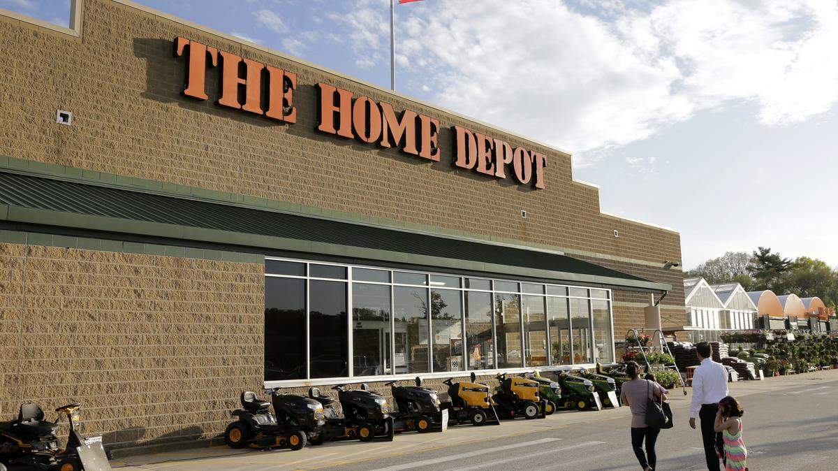 In this May 18, 2016, file photo, people approach an entrance to a Home Depot store in Bellingham, Mass. (AP Photo/Steven Senne, File)