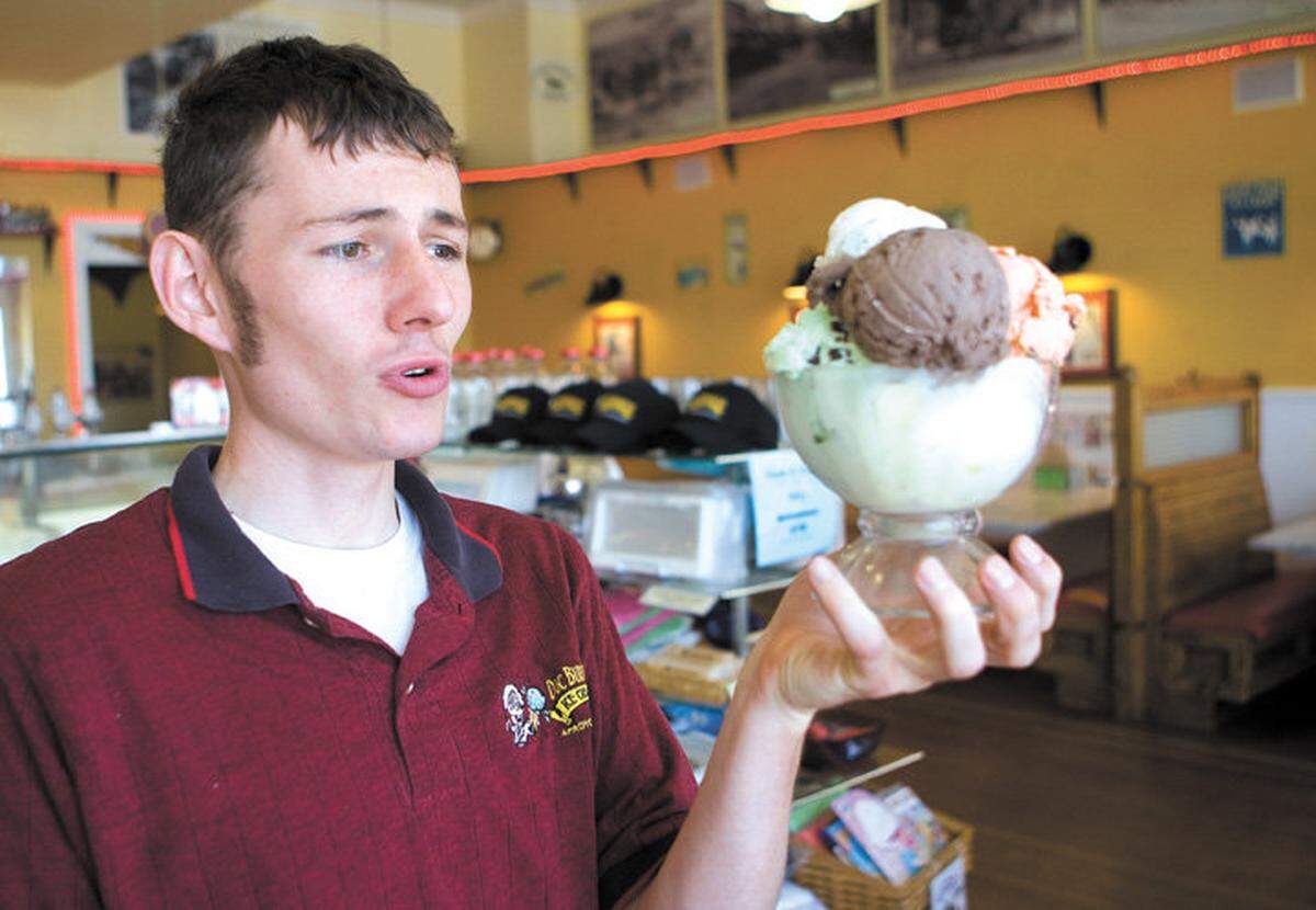 Doc Burnstein’s manager Aaron Luncford holds a piled-high bowl of ice cream in 2011.