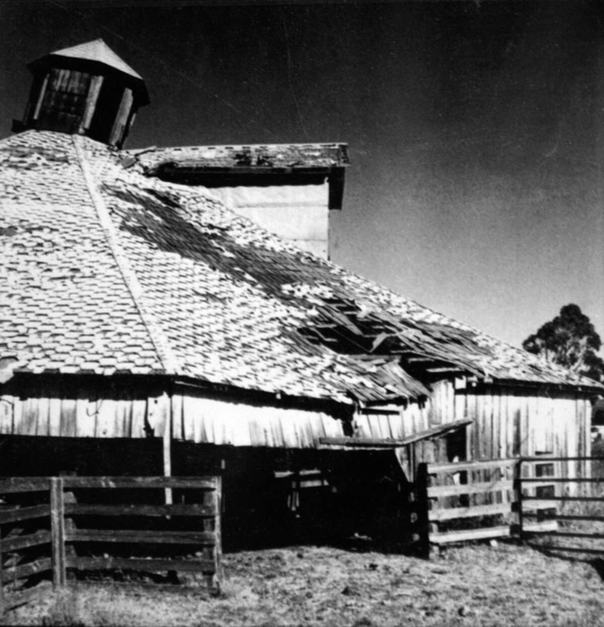 A photo hanging on the wall shows the Octagon Barn before it was restored, circa 1998.