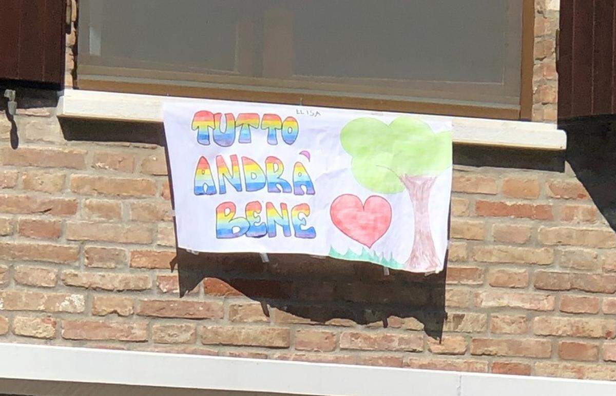 A sign hanging from the window of an Italian home reads “tutto andrà bene,” which translates to “I’ll be OK.”