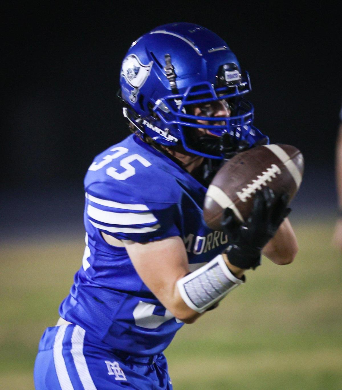 Bradley Safford gathers up the ball for Morro Bay in a game the Pirates led 28-13 over Fresno before it was canceled due to lightning on Sept. 9, 2022.