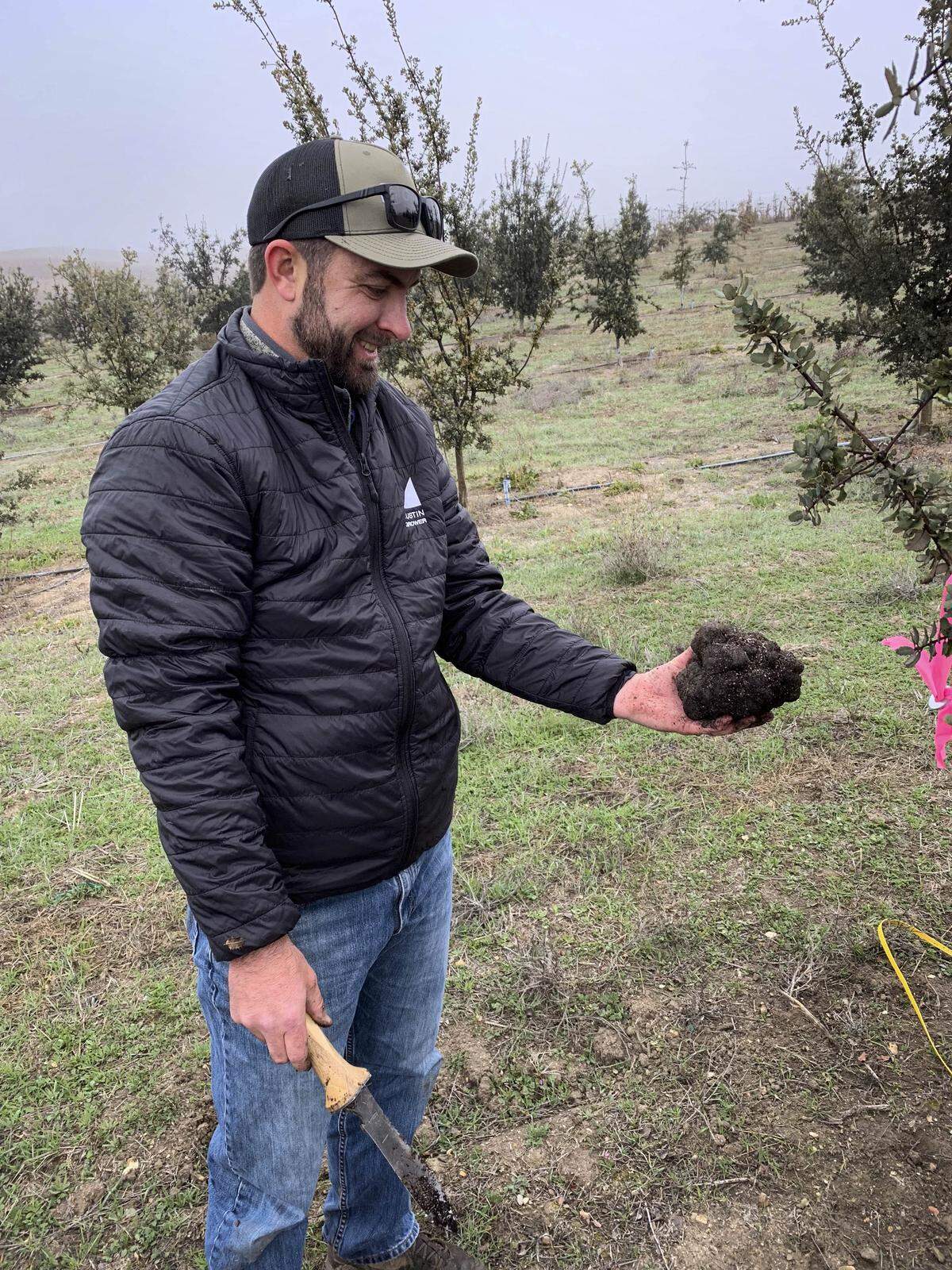 Carter Collins, Vineyard Management Care, Inc. holds a truffle.