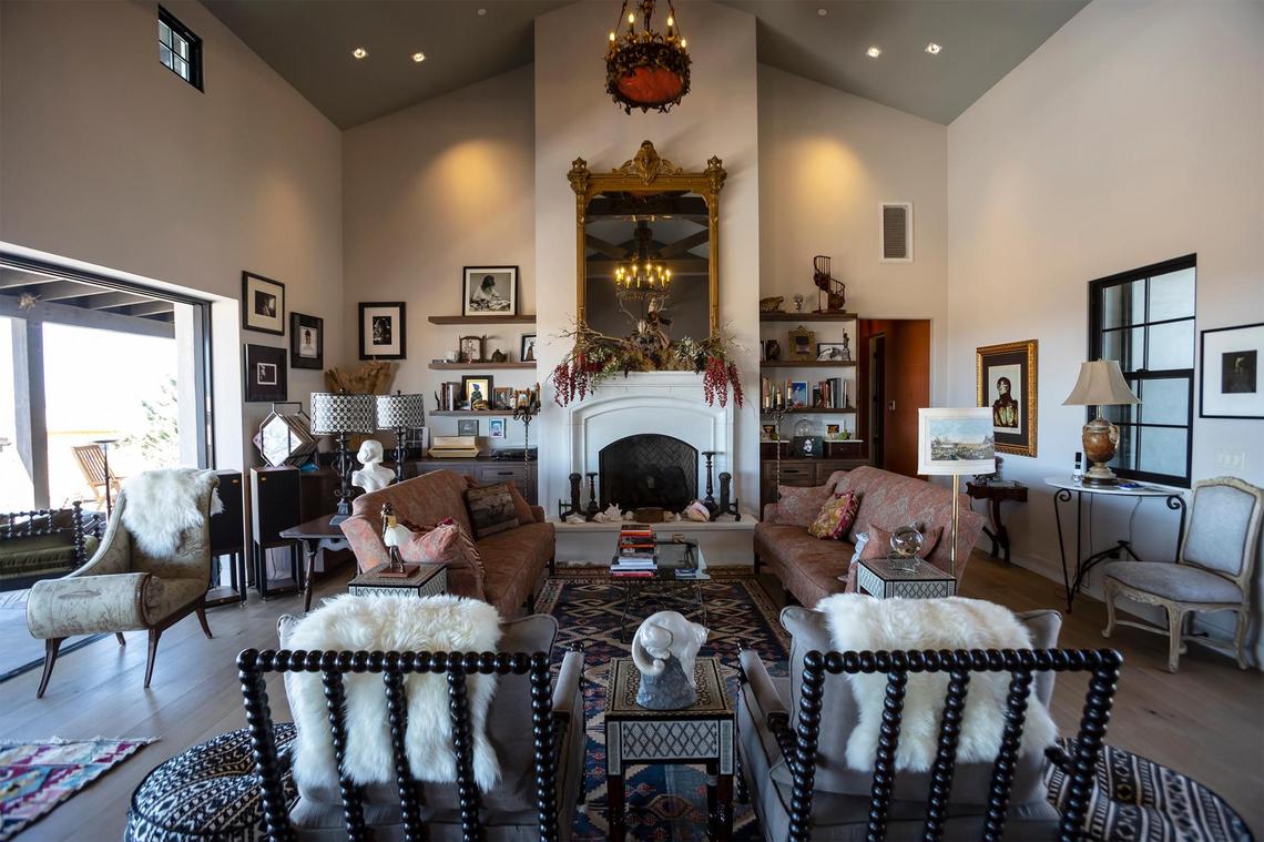 A large gilt mirror that once belonged to the Hotel del Coronado in San Diego hangs above the fireplace in the living room of the San Miguel home of Charles Miller and Tina Gulotta-Miller.
