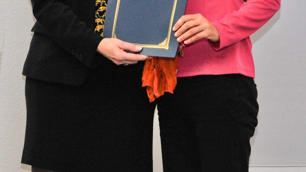 California Department of Child Support Services Director Alisha Griffin, left, presents an award to San Luis Obispo County Child Support Services Director Julie Paik, right. The local department ranked first out of 51 child support enforcement agencies in the state in overall performance.