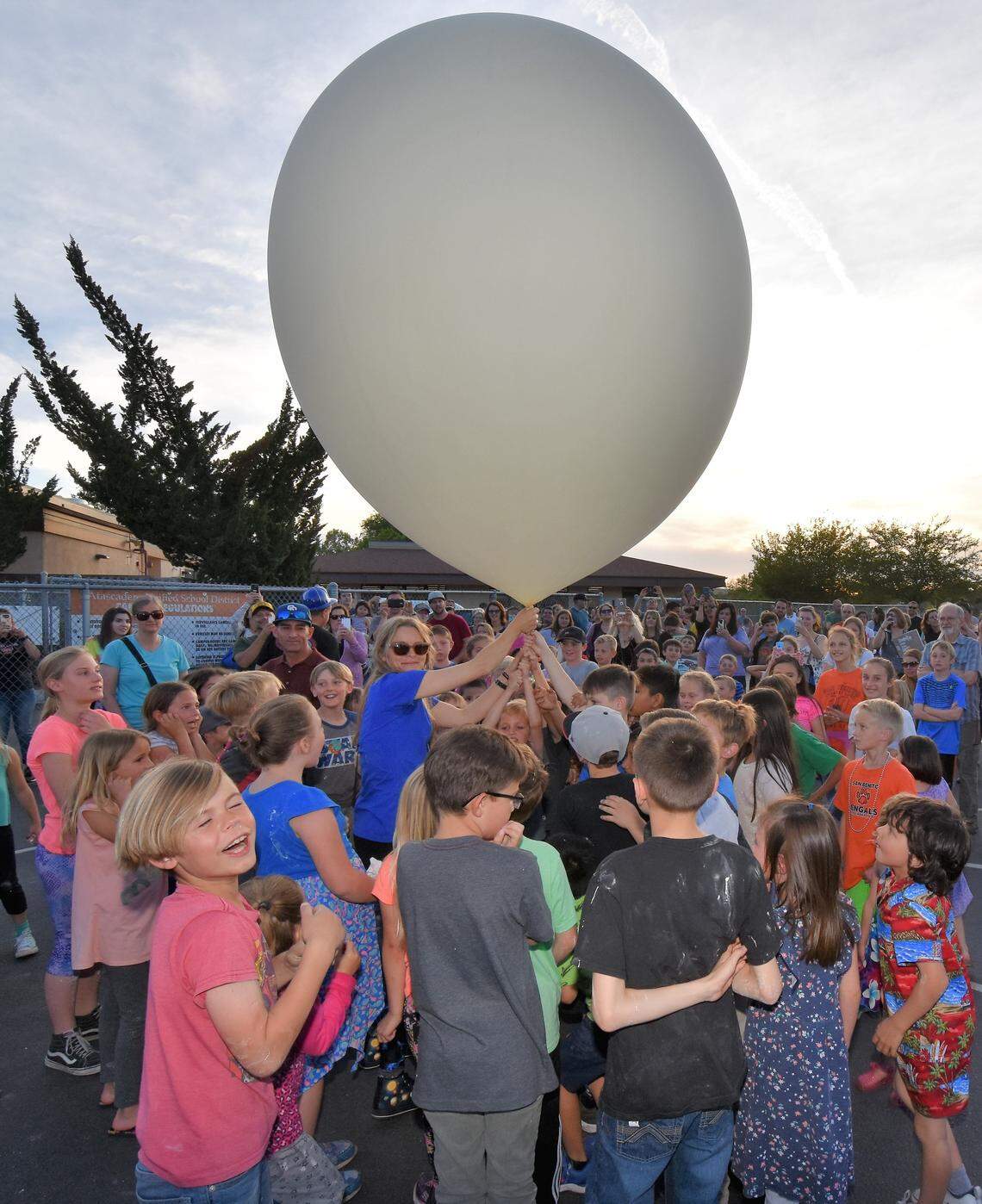 Cuesta College's math, astronomy and physics professor Michelle Kaul gets ready to release a weather balloon at Friday's Science Night at San Benito Elementary School in Atascadero. Weather balloons are used to predict the weather.