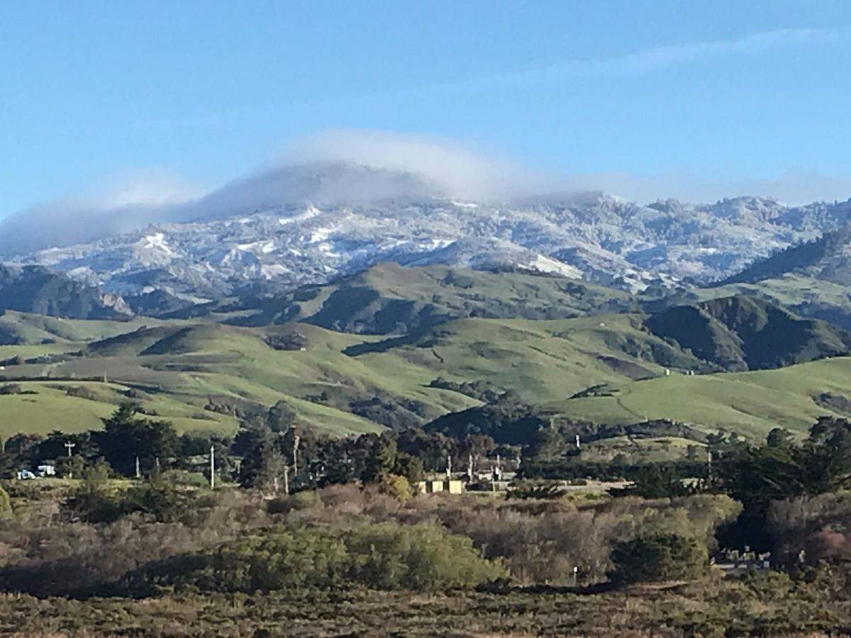 Snow coats the mountains north of San Simeon on Thursday, Feb. 23, 2023.