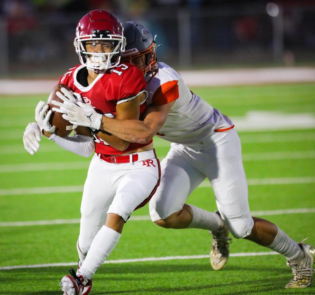 Tre Clark hauls in a pass tackled by Tyler Bukamier. Atascadero beat Paso Robles 28-14 at War Memorial Stadium on Sept., 1, 2023.
