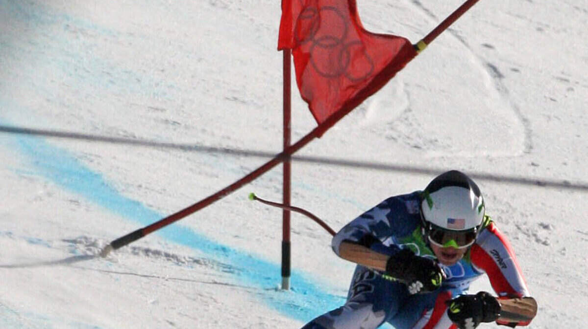 America's Bode Miller bashes a gate near the finish line during the men's Super-G. (Steve Ringman / Seattle Times / MCT)