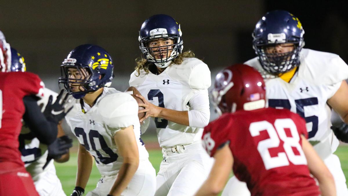 Arroyo Grande High School quarterback Ethan Royal looks downfield to pass against Paso Robles in the teams’ Mountan League opener Friday night.