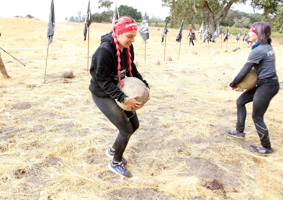 Jessica Beltran participates in the the stone carry at the Spartan race event held in Santa Margarita on Saturday, Nov. 2, 2024, featuring a variety of obstacles and courses of different challenge levels.