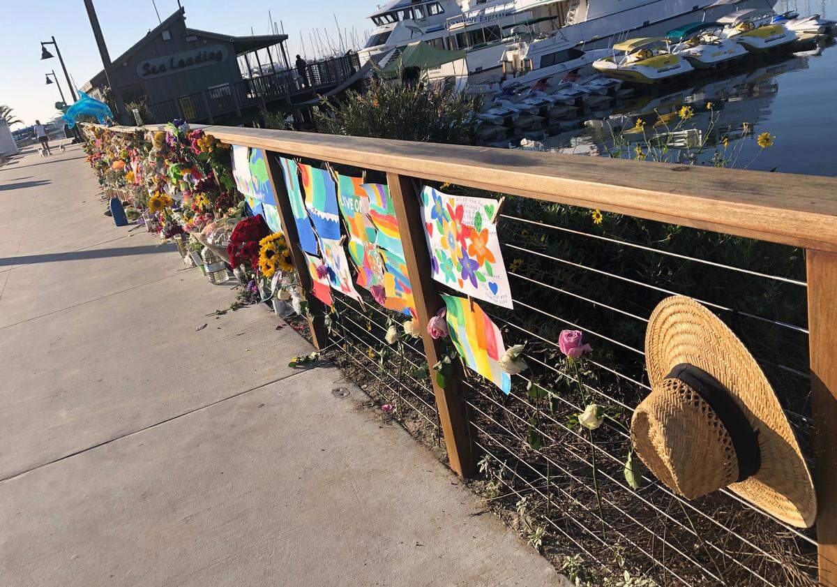 A growing memorial to those who died aboard the dive boat Conception is seen early Friday morning, Sept. 6, 2019 at the harbor in Santa Barbara. The Sept. 2 fire took the lives of 34 people on the ship off Santa Cruz Island off the Southern California coast near Santa Barbara.