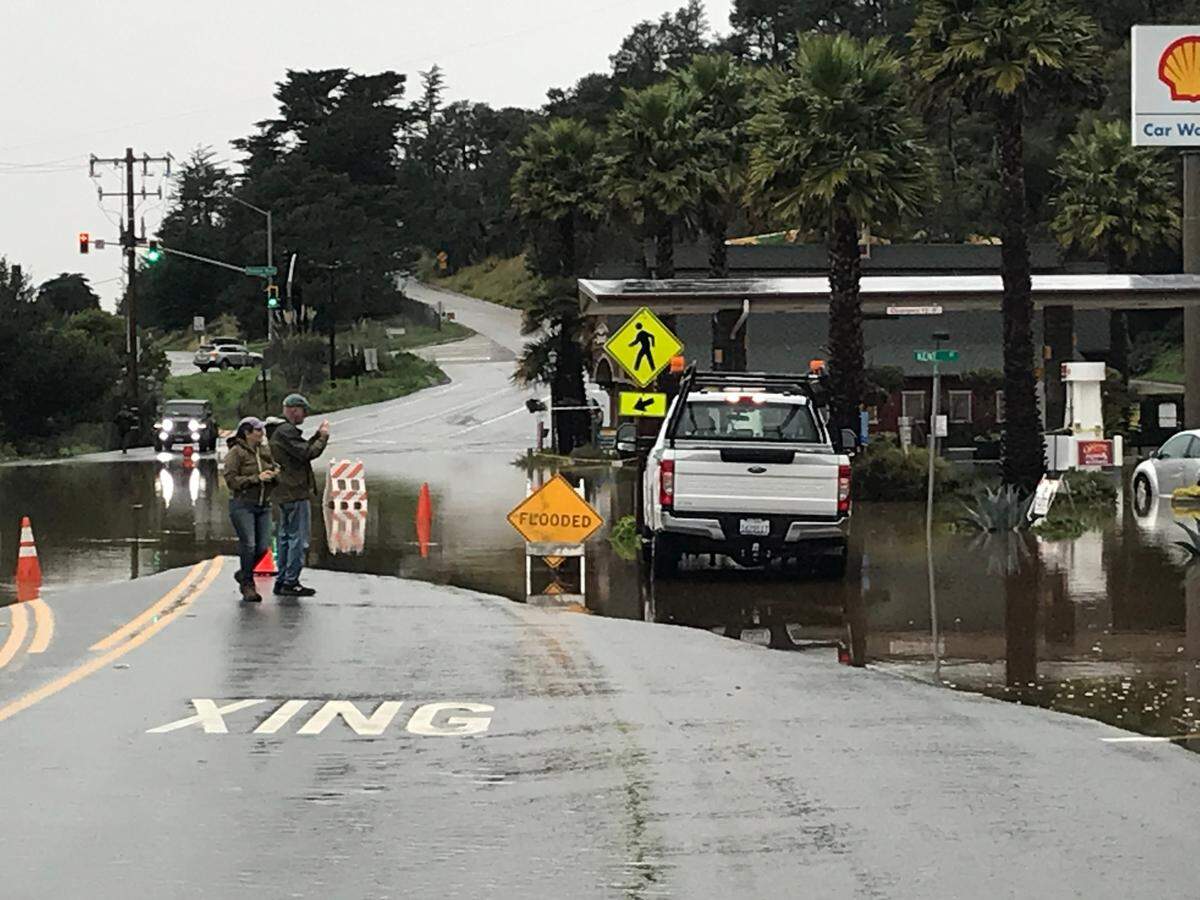 Cambria residents Diane and Darrel Boles scope out the flooding Jan. 9, 2023, at the town’s Shell service station.