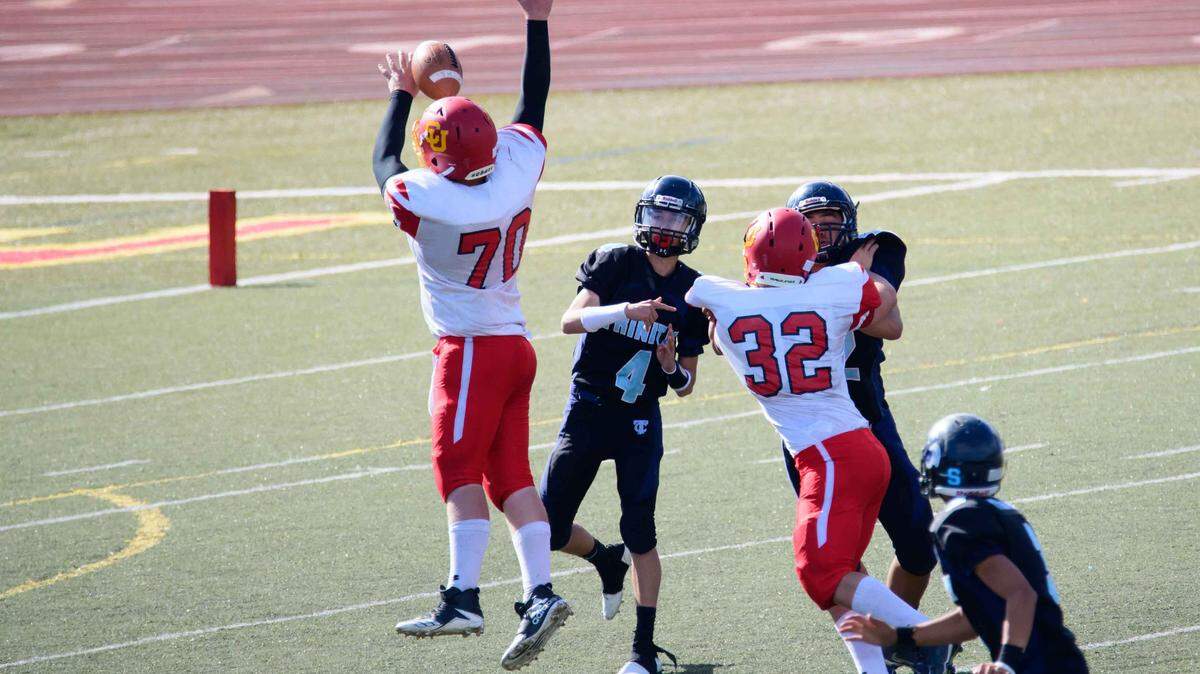 Coast Union High School junior linebacker Spencer Magnuson blocks a pass by Trinity Christian quarterback on Saturday, Sept. 29, in Pacific Grove.