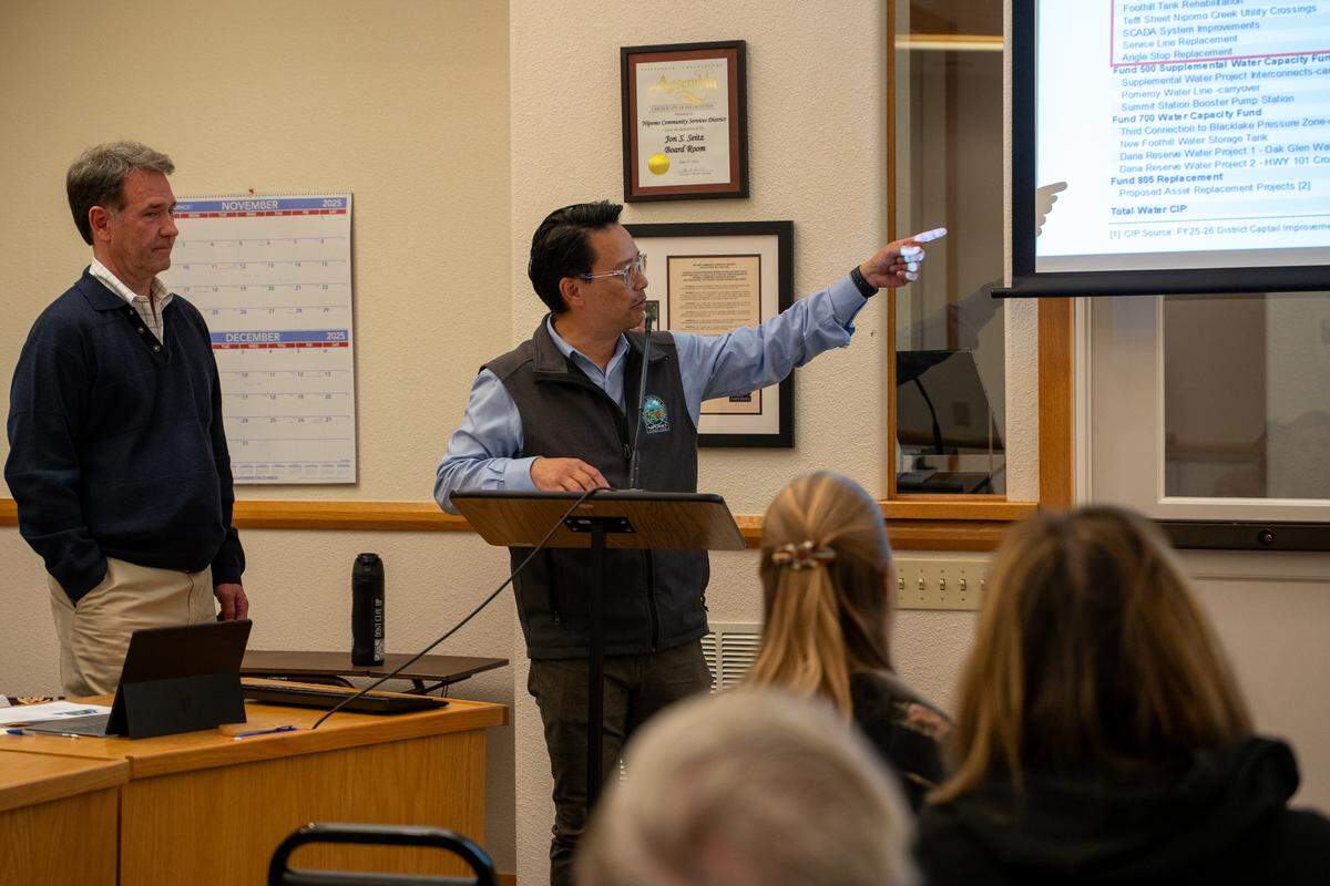 Consultant Clayton Tuckfield and Nipomo Community Services District general manager Ray Dienzo speak to a group of Nipomo residents at a town hall meeting on raising water rates on Thursday, Nov. 13, 2025. Average rate payers could see their water bill rise by 9.8% each year through 2028 if the rate increase is passed.
