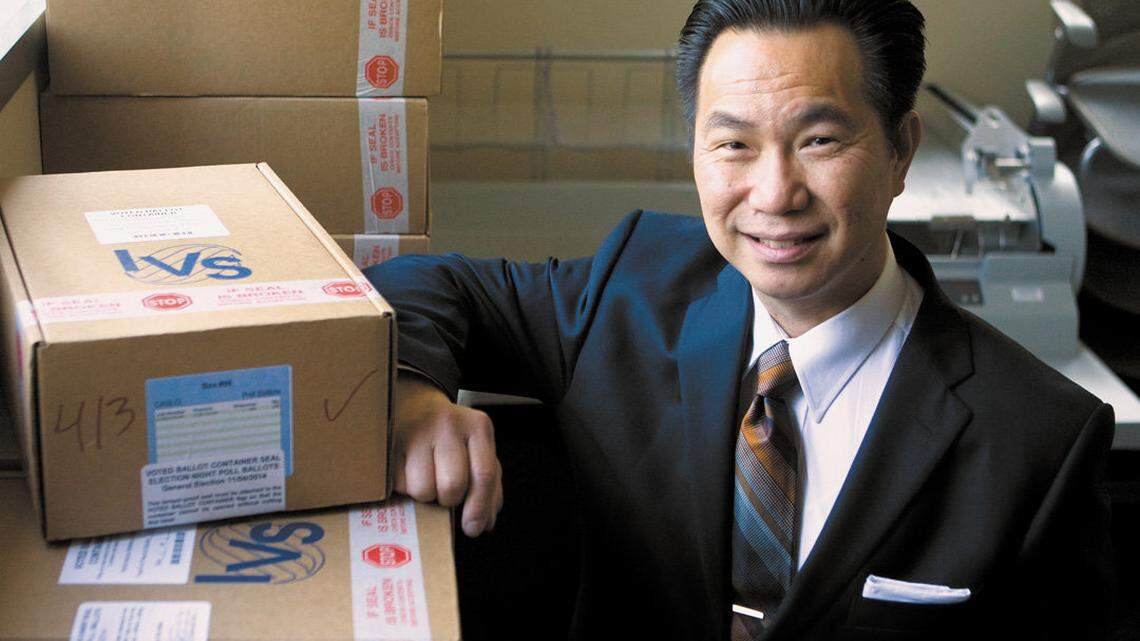 Tommy Gong, San Luis Obispo County's new clerk-recorder, stands next to boxes of ballots from the November 2014 election. The ballots will be stored for more than a year before they are destroyed.