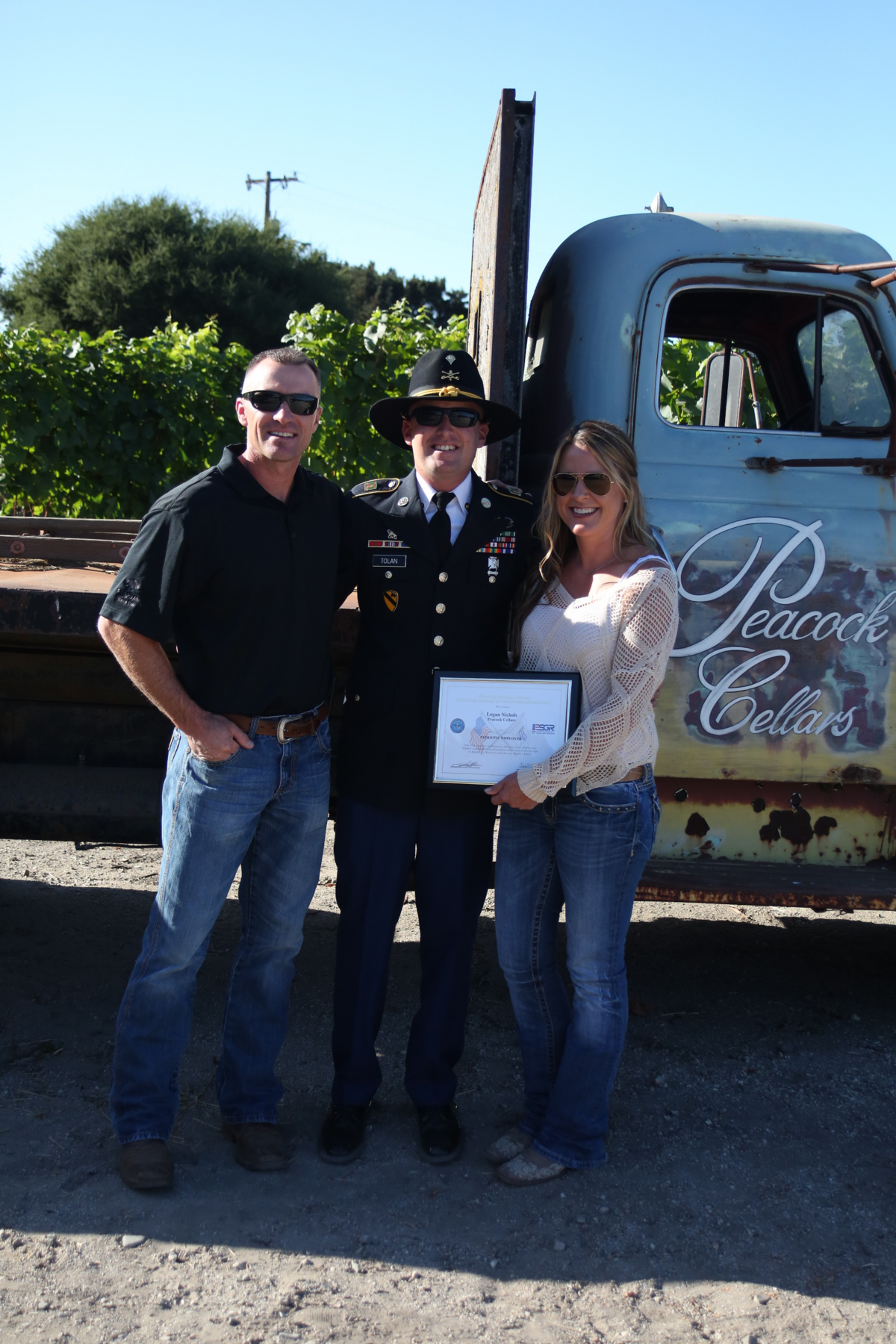 Robert Tolan, center, presented his bosses, Logan and Jessica Nichols, with the Patriot Award on Sept. 8, 2018. The award recognizes employers for supporting members of the National Guard and Army Reserve.