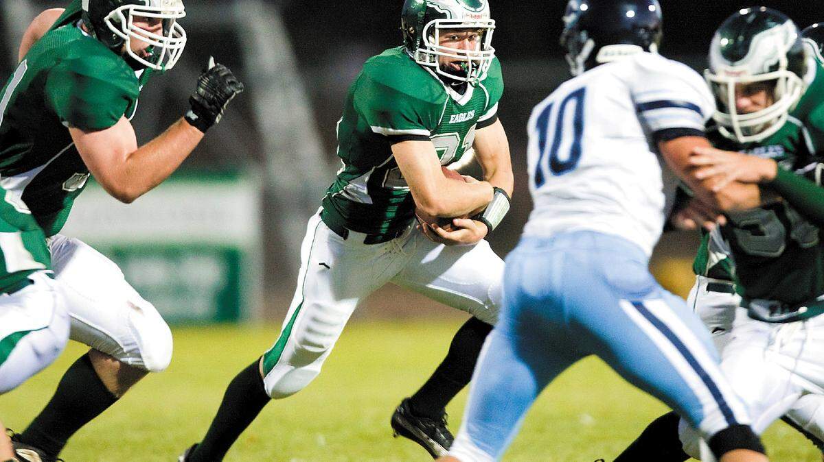 Templeton High running back Kory Dearie, center, looks for running room against Central Valley Christian’s Mitch Mouw during the Eagles’ 14-0 win Sept. 3 in Templeton.