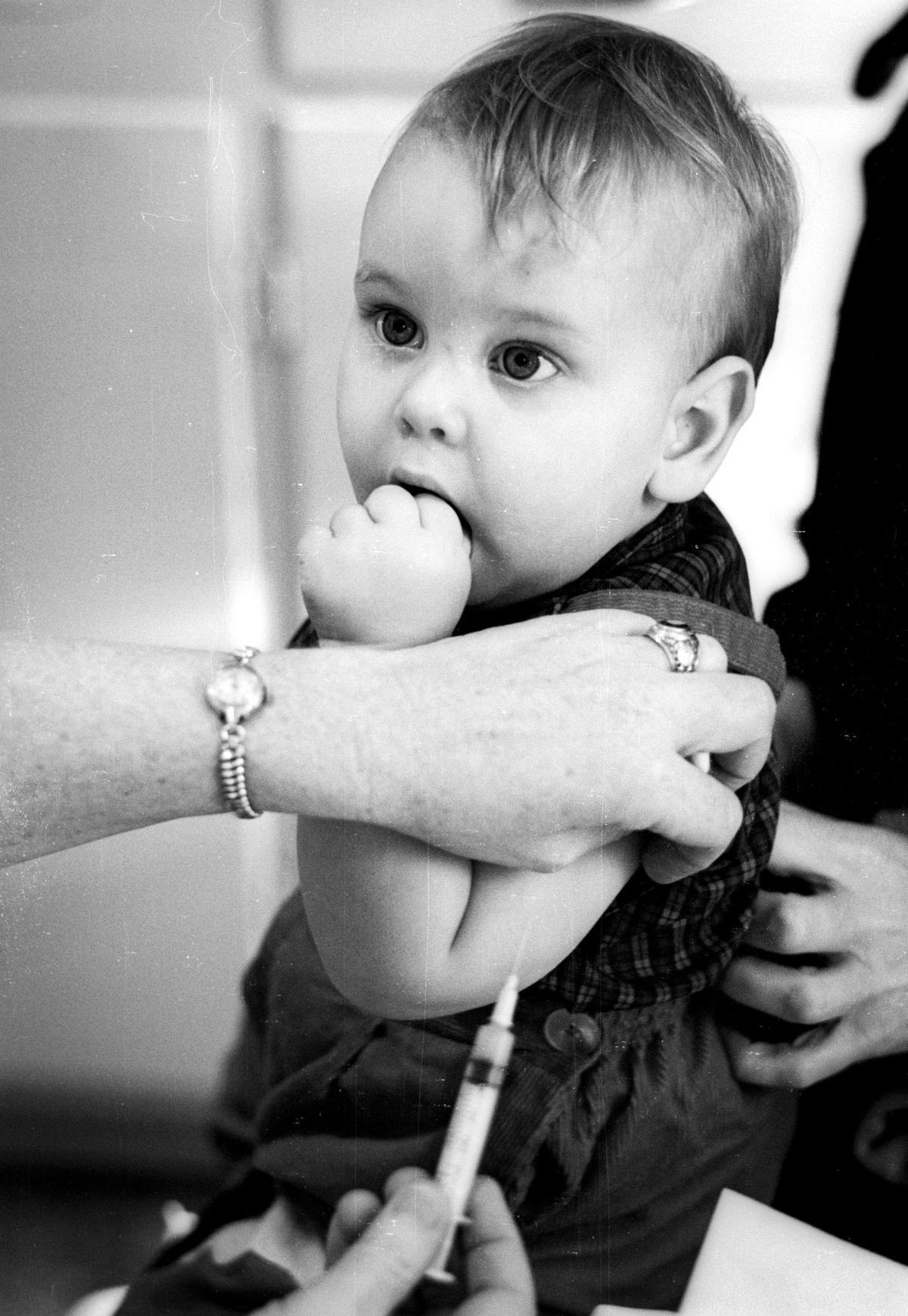 John Turano, 1 1/2 years old, holds up bravely and without a tear during County Health Department Immunization clinic in Atascadero Jan. 7, 1965.