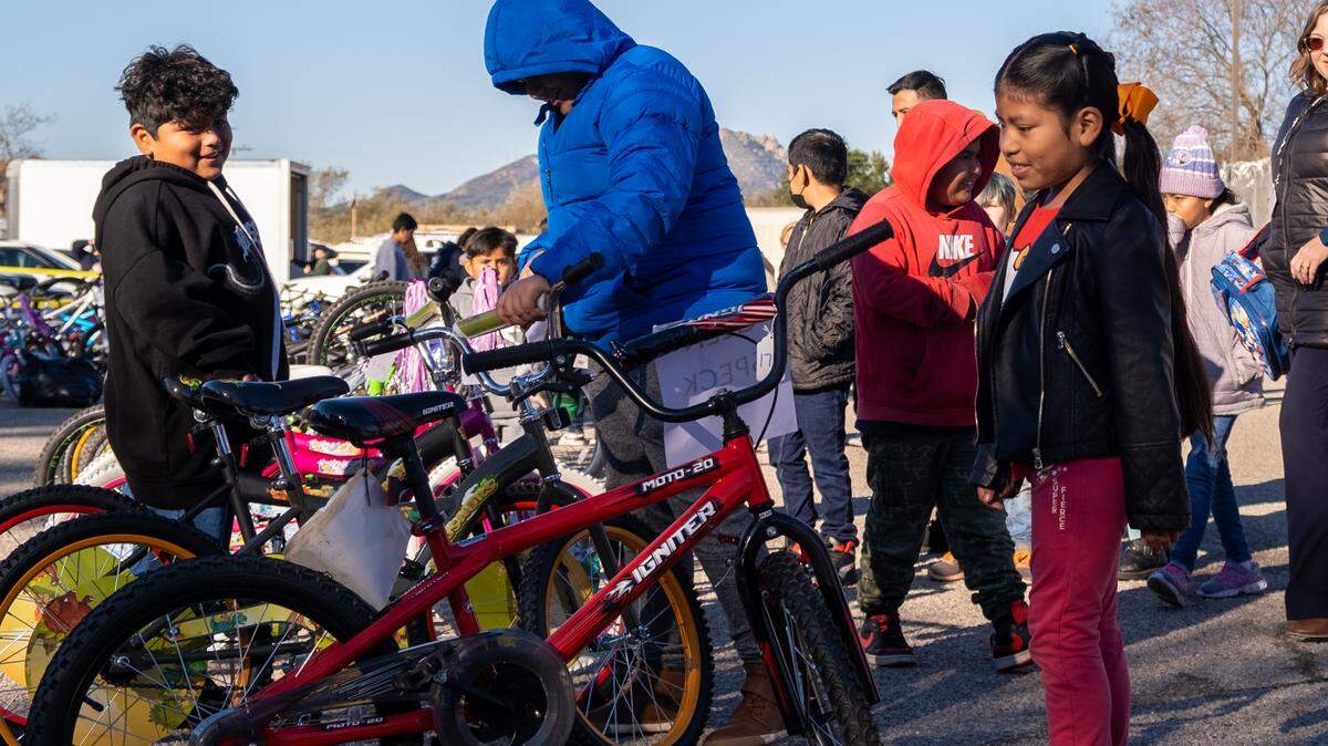 Bernadita Flore, 9, looks at the new bike she got during the San Luis Obispo County Sheriff’s Office bicycle giveaway on Dec. 13, 2022 — Flore’s birthday.