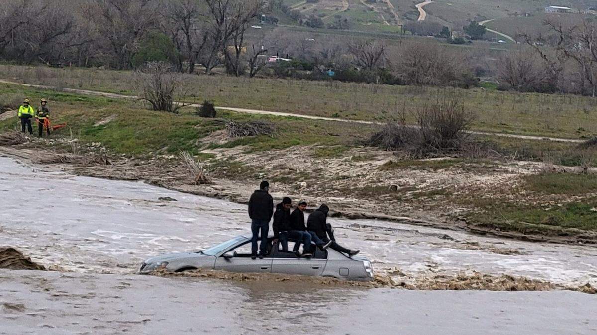 Four people were stranded on the roof of a car in Paso Robles after attempting a low water crossing on Sunday, Feb. 26, 2023.