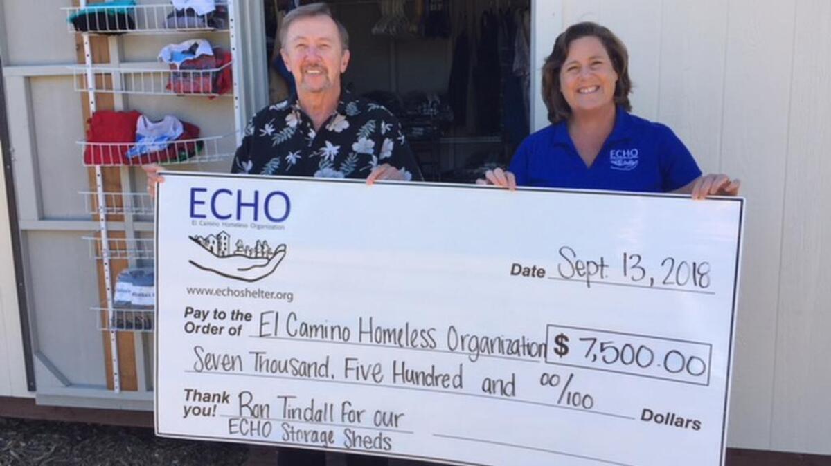 From left, Ron Tindall, RN, presents a check in the amount of $7,500 to ECHO President/CEO Wendy Lewis for the purchase of three storage sheds.