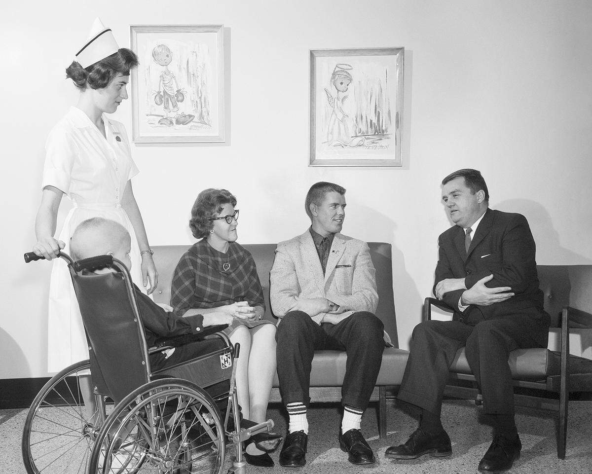 An unnamed family speaks with Dr. Donald Pinkel, medical director of St. Jude Children’s Research Hospital, in December 1962.