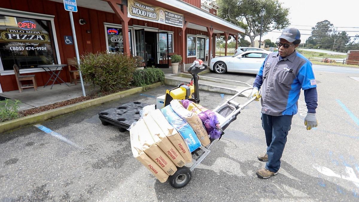 Truck driver Robert Calhoun makes a delivery stop at Palo Mesa Pizza.