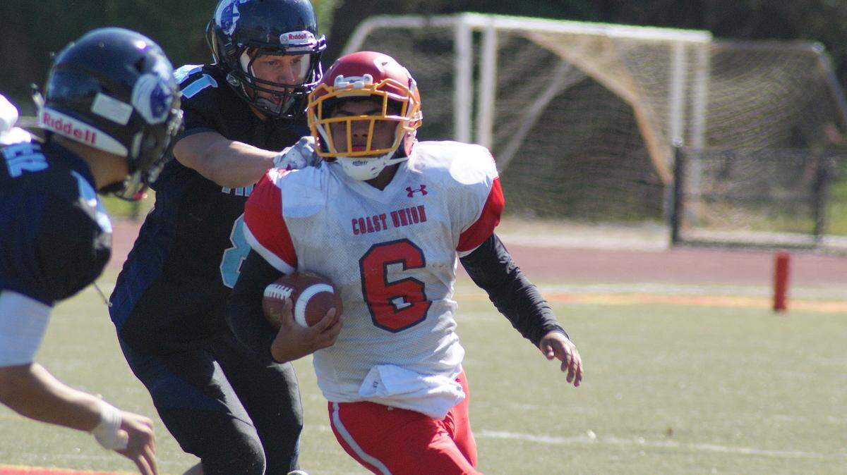 Coast Union High School freshman halfback Emi Pena (who also plays quarterback) scored six touchdowns against Maricopa on Friday night, Oct. 5. Here, he picks up yardage against Trinity Christian on Sept. 30.