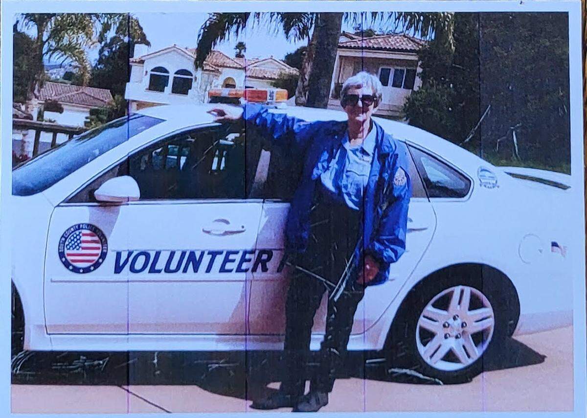 Former Grover Beach City Council member Barbara Nicolls poses with a police volunteer car. Nicolls died on Jan. 31, 2024.