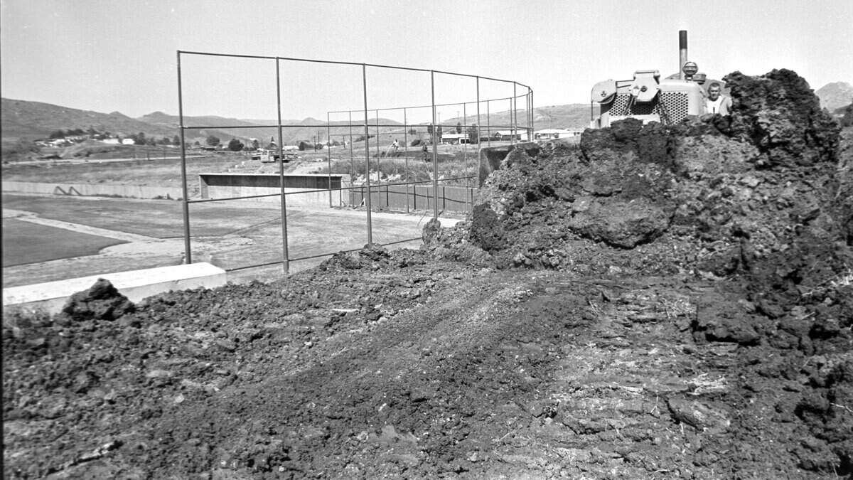 Bulldozer moves soil behind the backstop at Sinsheimer Stadium during construction at the baseball field April 25, 1970.