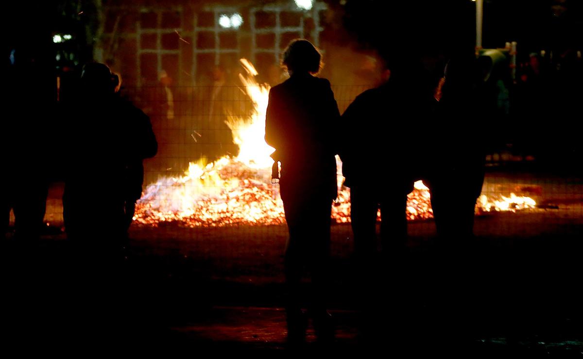 People enjoy a bonfire at the city of Paso Robles’ first New Year’s Eve celebration in Downtown City Park.