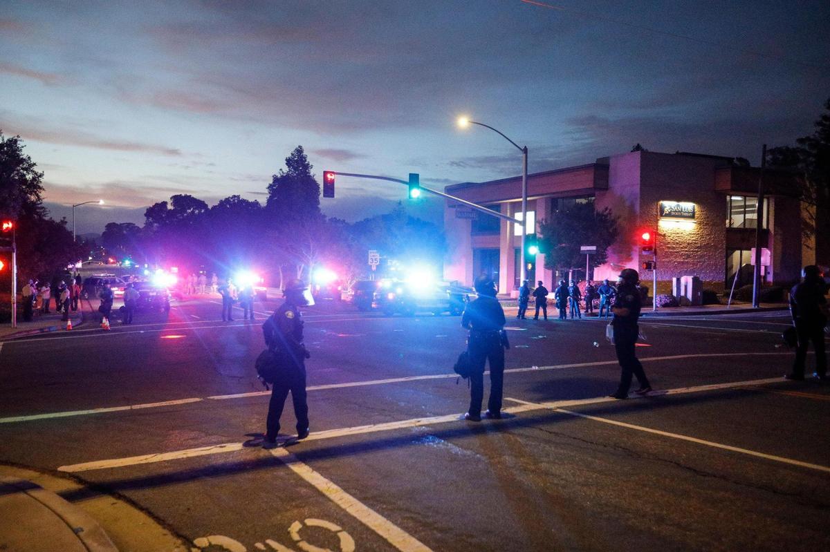 San Luis Obispo police officers, sheriff deputies and officers stand guard at the Santa Rosa Street and Walnut Street intersection next to the police station, on Monday, June 1, 2020.
