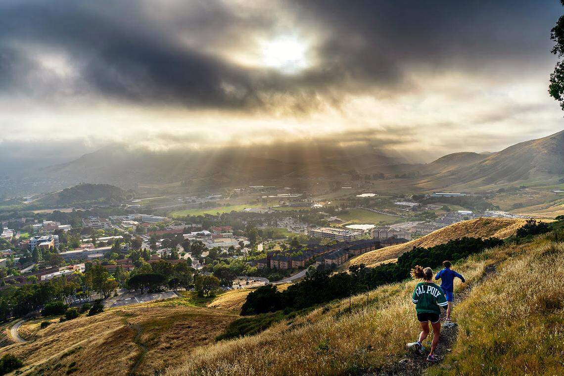 Multiple examples of a sunbreak can be see here as two students hike the hill.