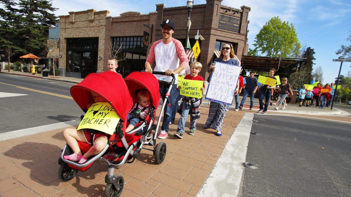 Lucia Mar Unified School District parents and families march through the Arroyo Grande Village in support of the teachers union in March.