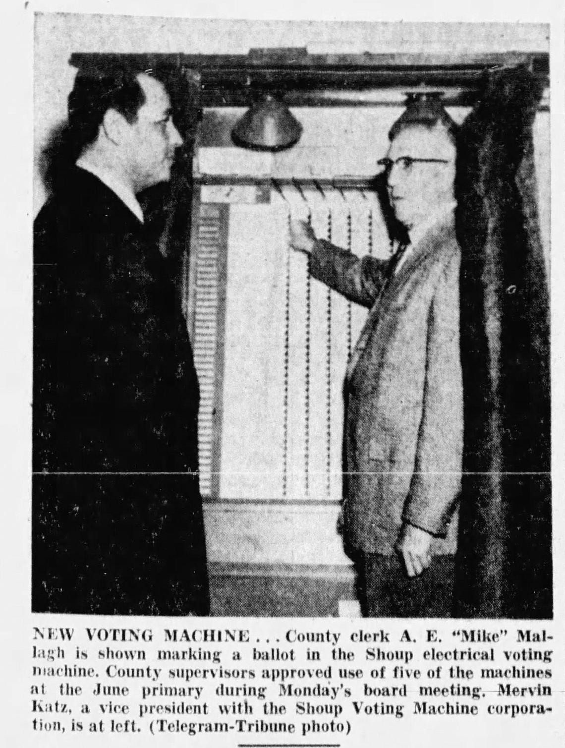 County clerk A.I. “Mike” Mallagh is shown marking a ballot in the Shoup electrical voting machine in 1957. County supervisors approved use of five of the machines at the June primary. Mervin Katz, a vice president with the Shoup Voting Machine corporation is at left.