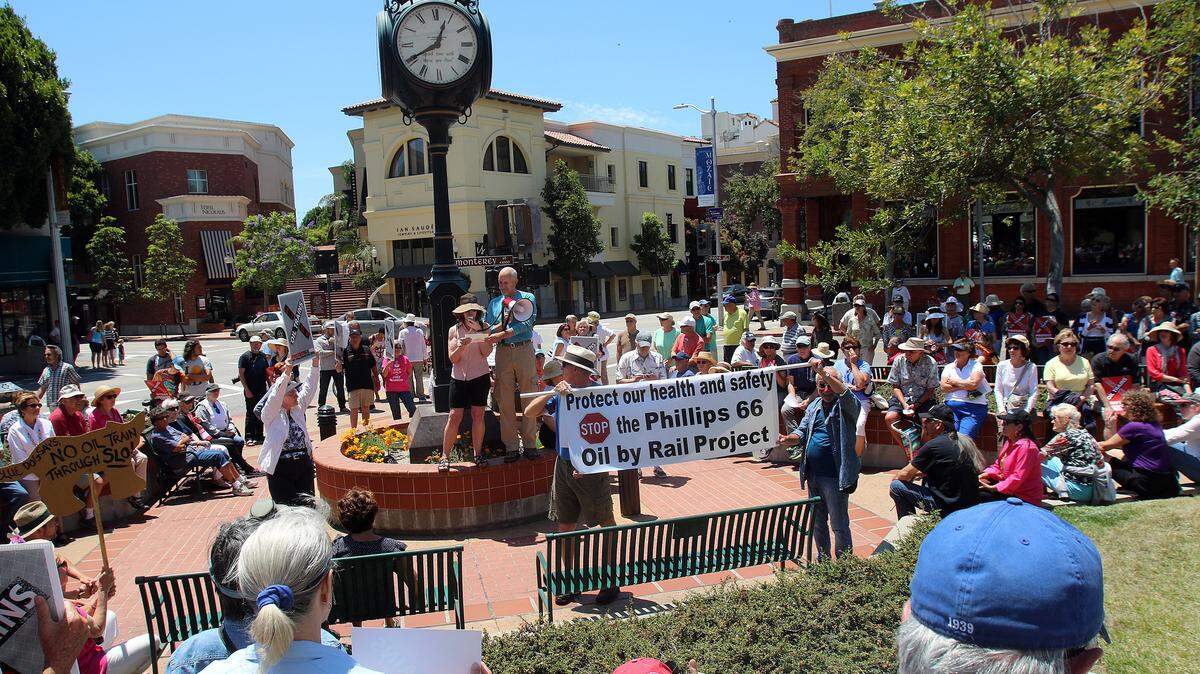 Charles Varni and retired Lucia Mar teacher Kathleen Minck speak during a protest Saturday in San Luis Obispo. A couple of hundred people rallied to protest the Phillips 66 proposal to bring oil by train to its Nipomo Mesa refinery. Speakers included San Luis Obispo Mayor Jan Marx, Santa Barbara County Supervisor Salud Carbajal and Varni, representing the San Luis Obispo Surfriders' Association.