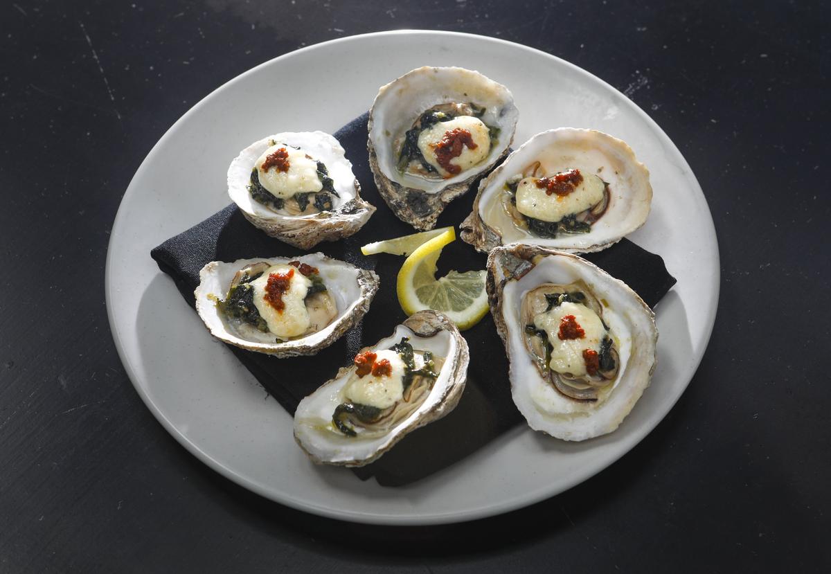 Blue Point oysters are topped with a blend of tequila, chipotle, spinach, asiago cheese and chorizo at La Esquina Taqueria in downtown San Luis Obispo.