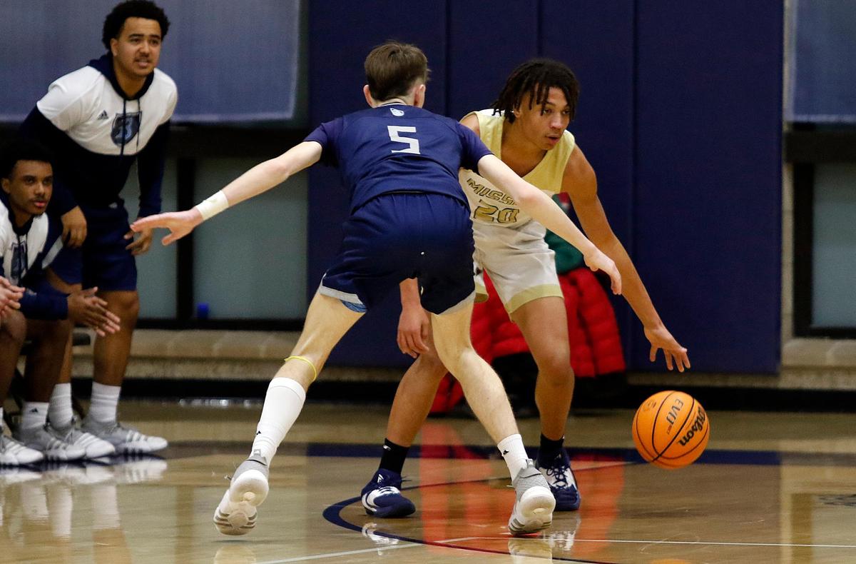 Mission Prep’s Jayden Nozil (20) comes up against Bullard’s defender Major Hurley (5). The Mission Prep boys basketball team beat Bullard High School 66-50 in a first-round playoff game in San Luis Obispo, Feb. 15, 2023.