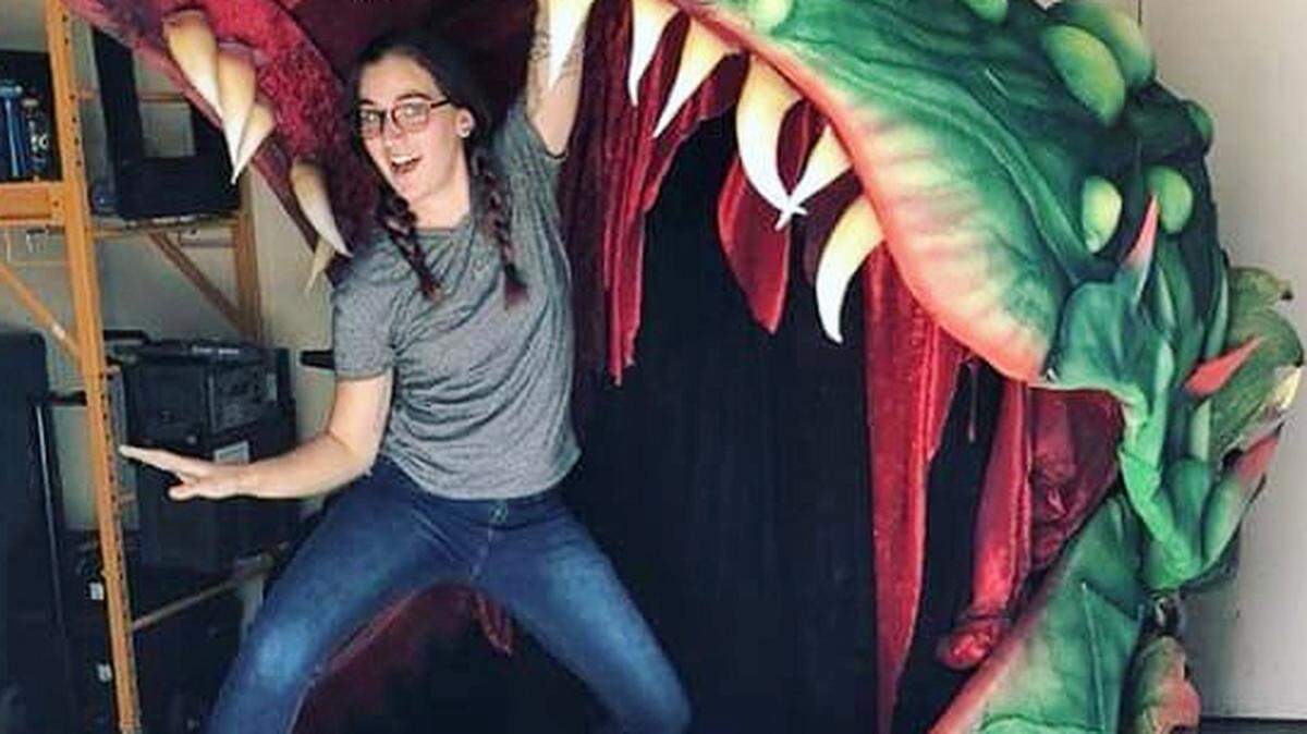 Artist Caity Tanner (granddaughter of the columnist) strikes a pose in the mouth of the “Audrey II” puppet of a man-eating plant she helped to create for the Broadway Sacramento production of “Little Shop of Horrors” last month.