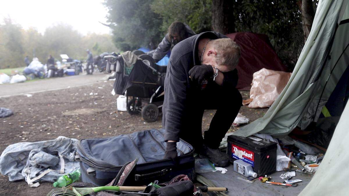 Chad Lamb, 49, is overcome with emotion after being evicted from an encampment on the Bob Jones Trail in January.