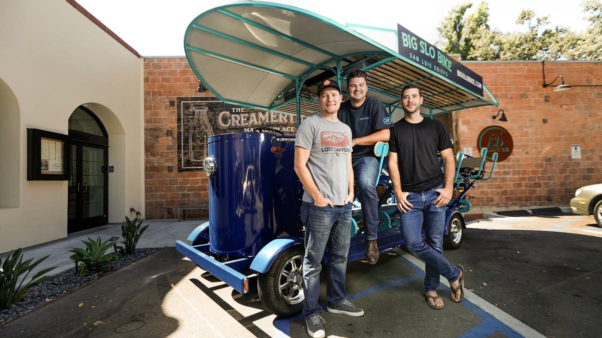 Johnny May, left, Wes Zimmerman and Jay Winter of Big SLO Bike pose with their giant bike outside the Creamery in San Luis Obispo.
