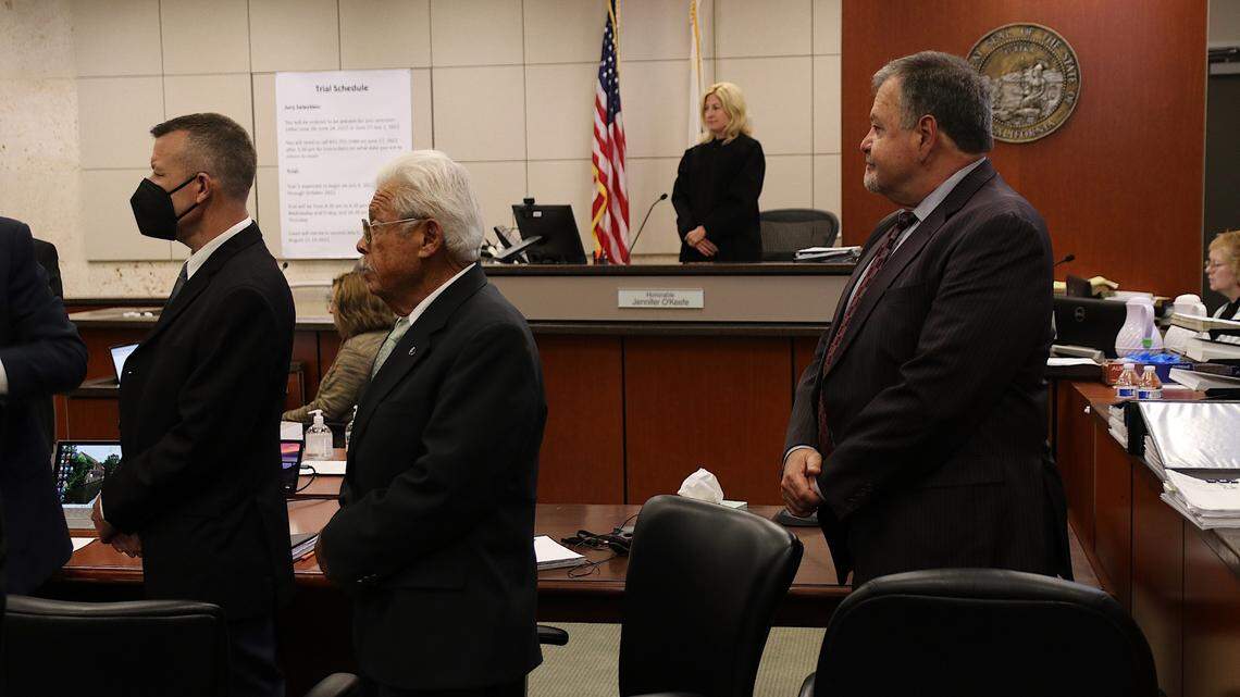 From left to right, Paul Flores, his father, Ruben Flores, Monterey County Superior Court Judge Jennifer O’Keefe and Ruben Flores’ defense attorney, Harold Mesick, stand in Monterey County Superior Court in Salinas on Sept 26, 2022. The two Flores men are on trial in connection with the 1996 murder of Kristin Smart.