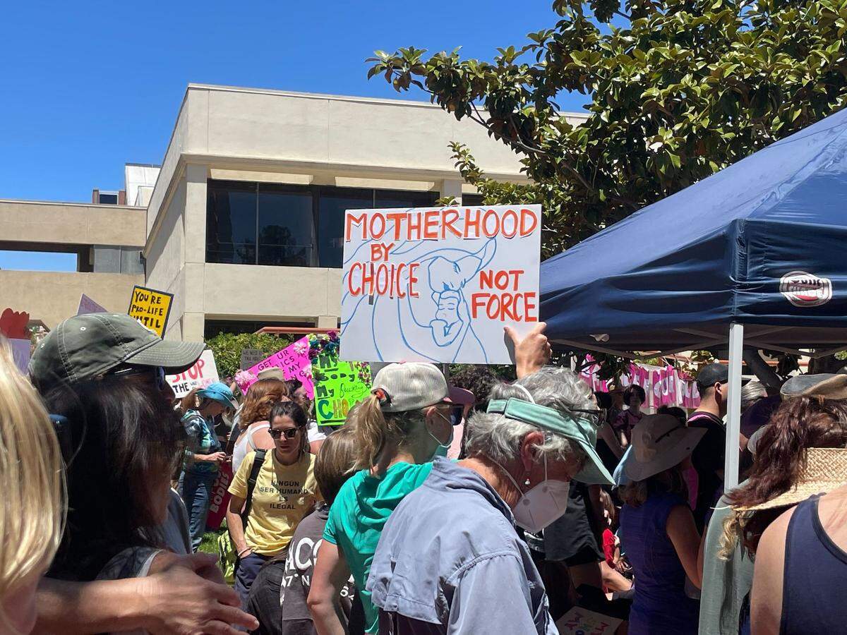 At a Planned Parenthood march in Downtown SLO, one attendee holds a sign that reads “Motherhood by choice, not force,” on Saturday, May 14, 2022.