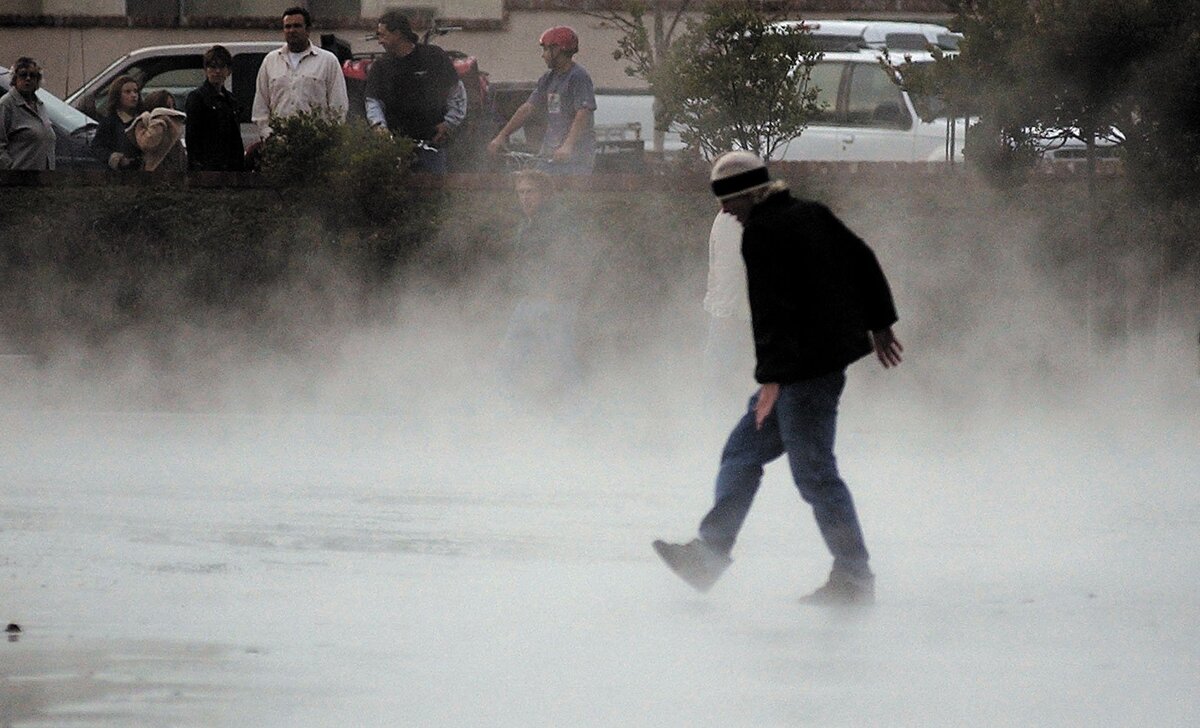 Paso Robles pedestrians stop to look steam rising from the sulpher hot spring that opened up in the parking lot behind city hall after a 6.5 magnitude earthquake. The spring had been capped decades ago but the earthquake opened it up again Dec. 22, 2003.